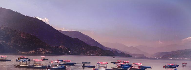 Boats on Phewa Lake with Himalayan backdrop – Nepal Tour Package from India